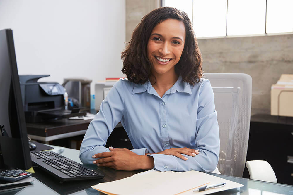 smiling agent at desk