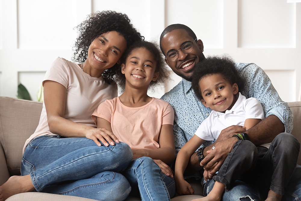 smiling family on couch