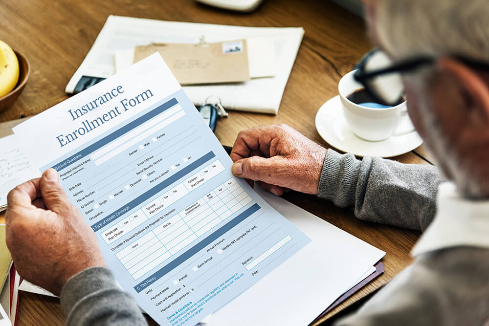 over the shoulder perspective of a senior holding an enrollment form